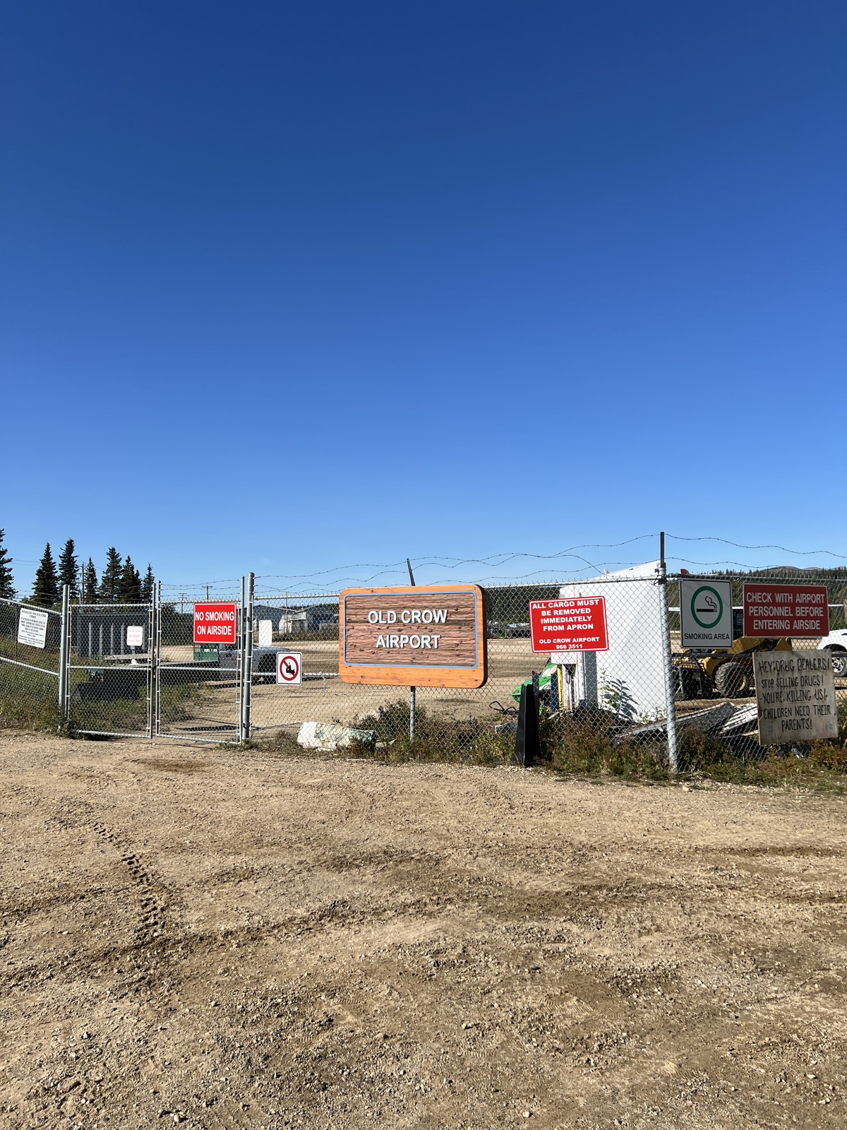 The Old Crow Airport sign under a clear blue northern sky